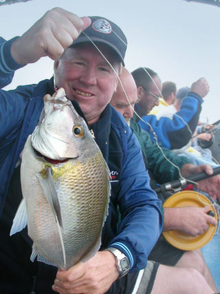Happy angler with fresh catch aboard MV Kostalota
